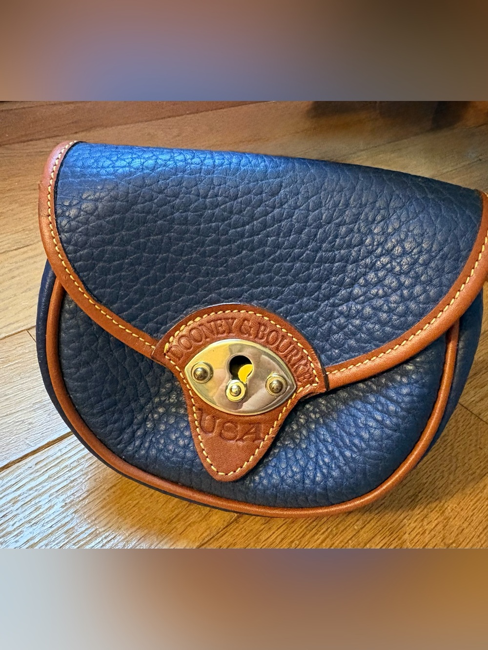 Dooney & Bourke cavalry mini bag. Navy Pebbled Leather Crossbody with Brown Trim